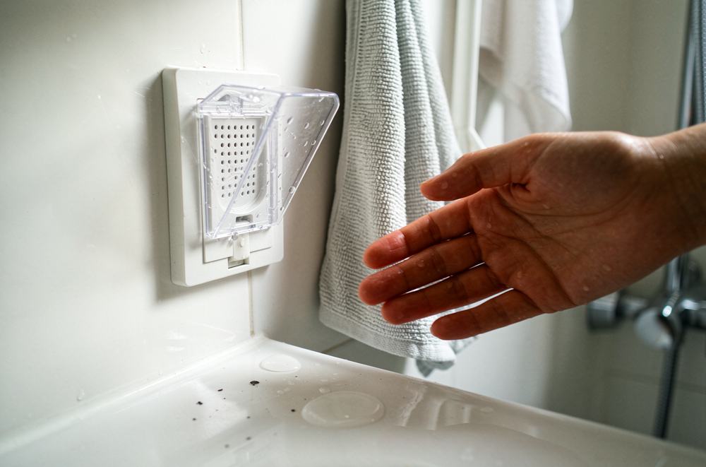 A splash-proof socket next to a bathroom sink